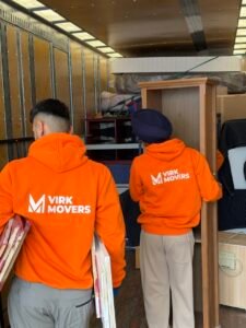Virk Movers team members carefully load furniture and household items into a moving truck for safe transportation