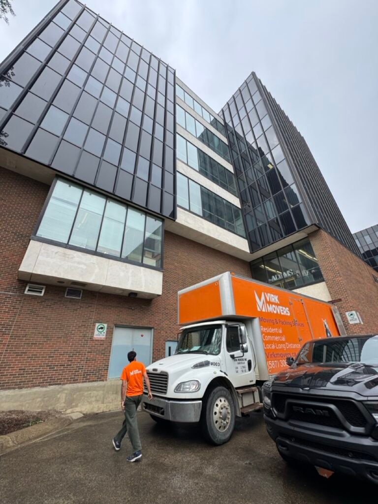 Virk Movers truck parked outside a commercial building, ready to provide reliable office and commercial moving services.